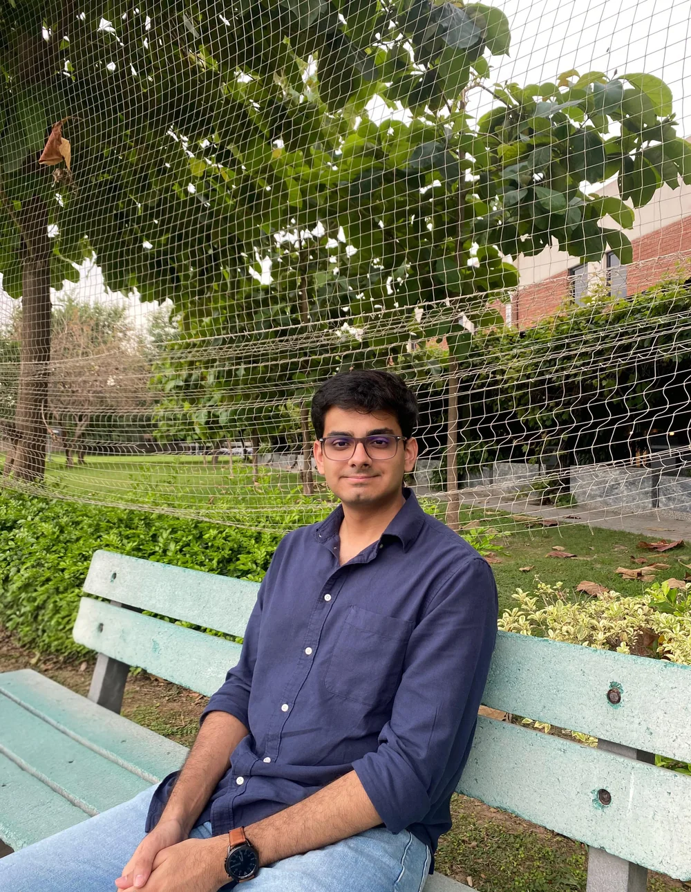 Taimur Hassan Sarmad sitting on a park bench